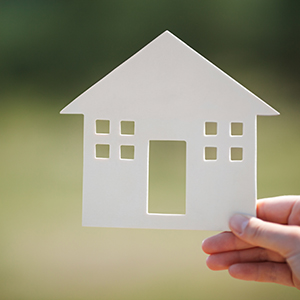 Hand holding house model outdoor